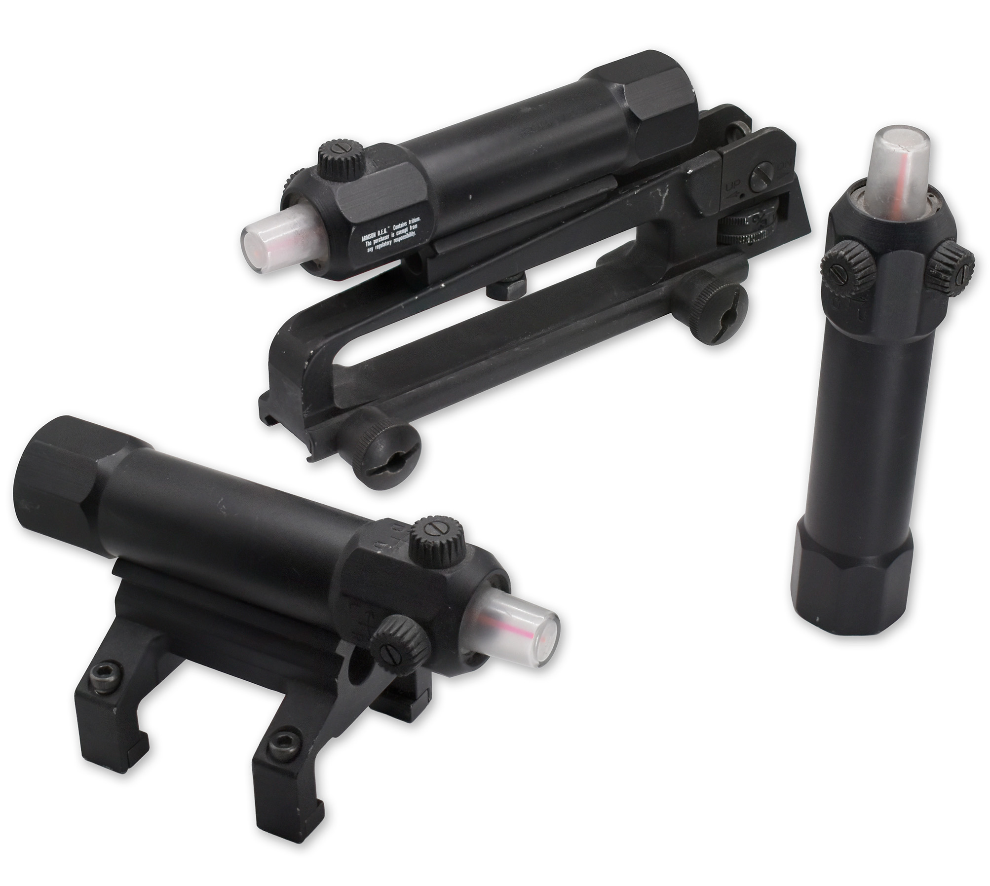 A collection of tactical equipment components, including a mounted light and adjustable sights in a black finish.