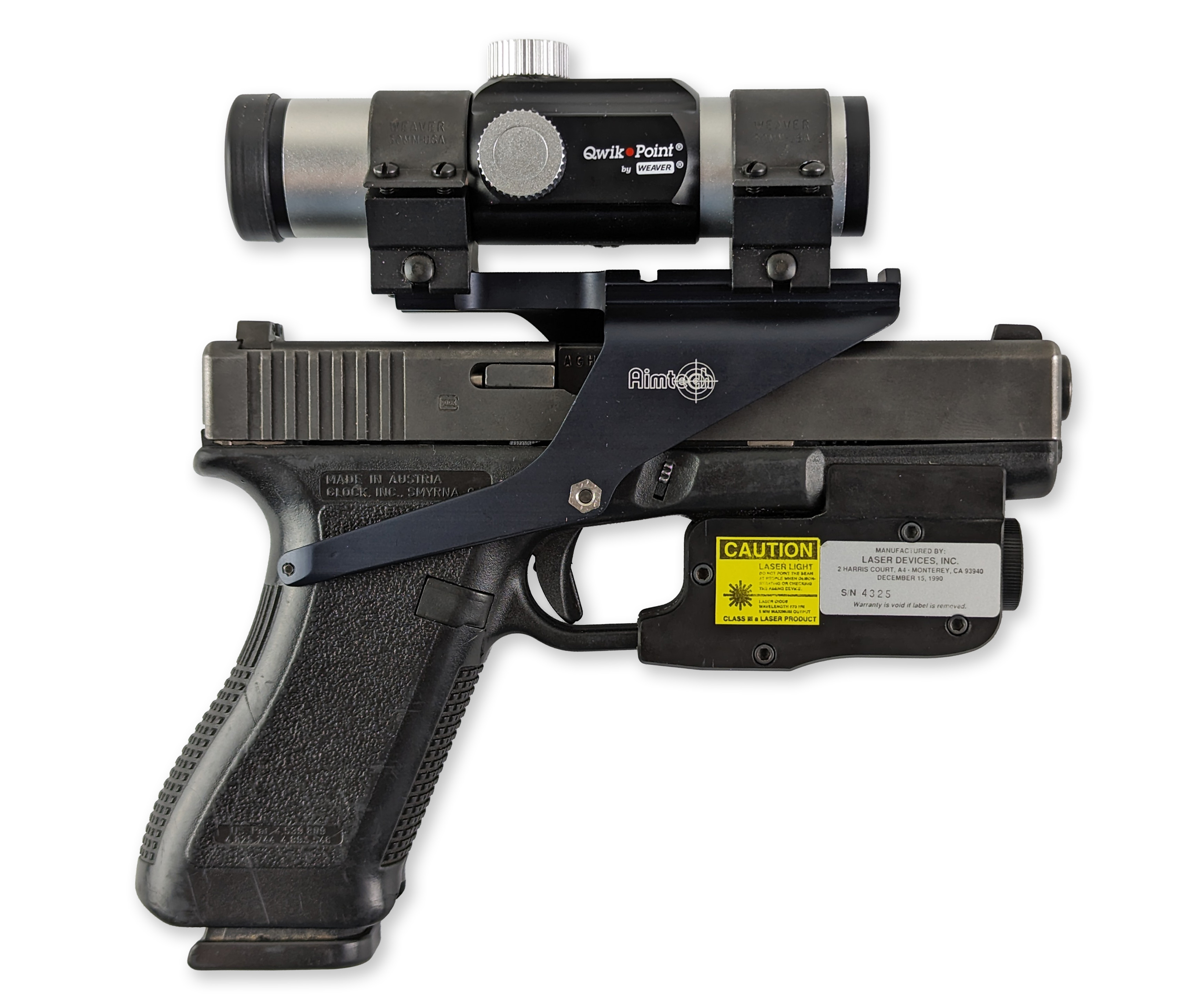A Qwik-Point optic mounted on a handgun, showcasing its design and integration with the firearm.