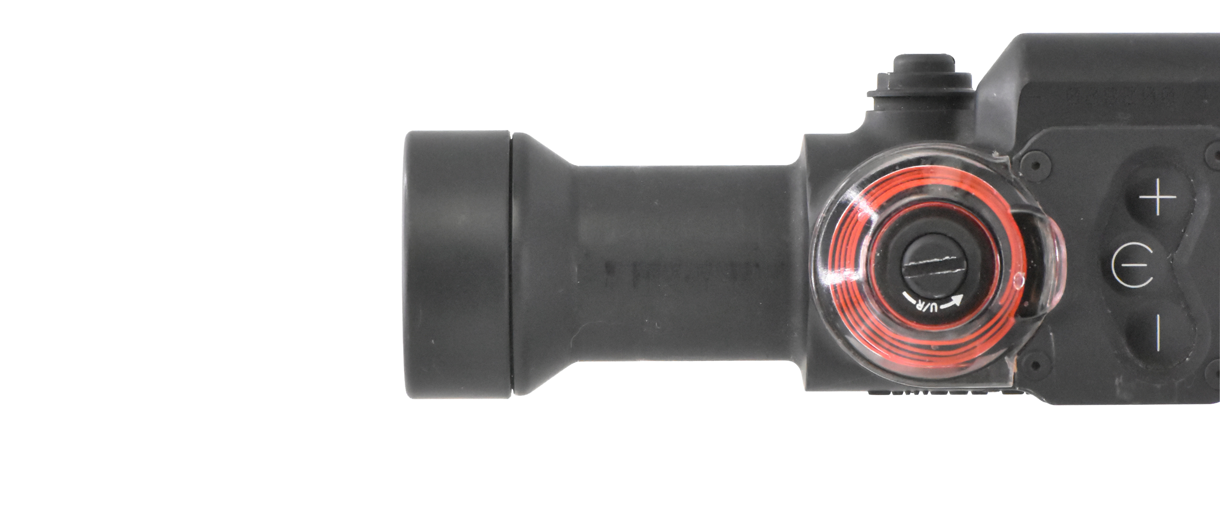 Top view of a Trijicon TX30 optic, showing the adjustment knob and fiber optic housing with red illumination.