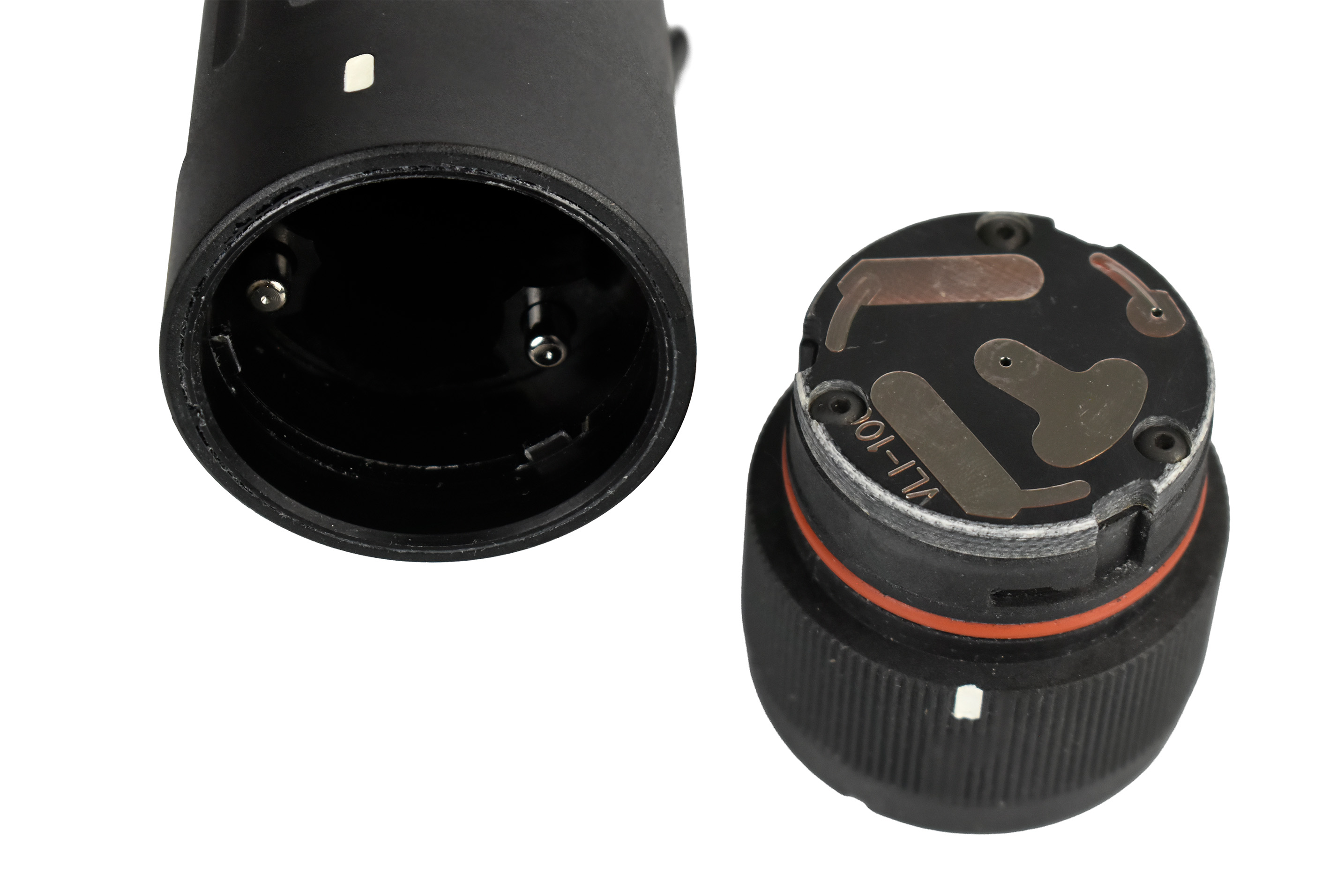 Close-up of the connection interface and control dial of a Visible Light Illuminator (VLI), showcasing metal contact points and markings.