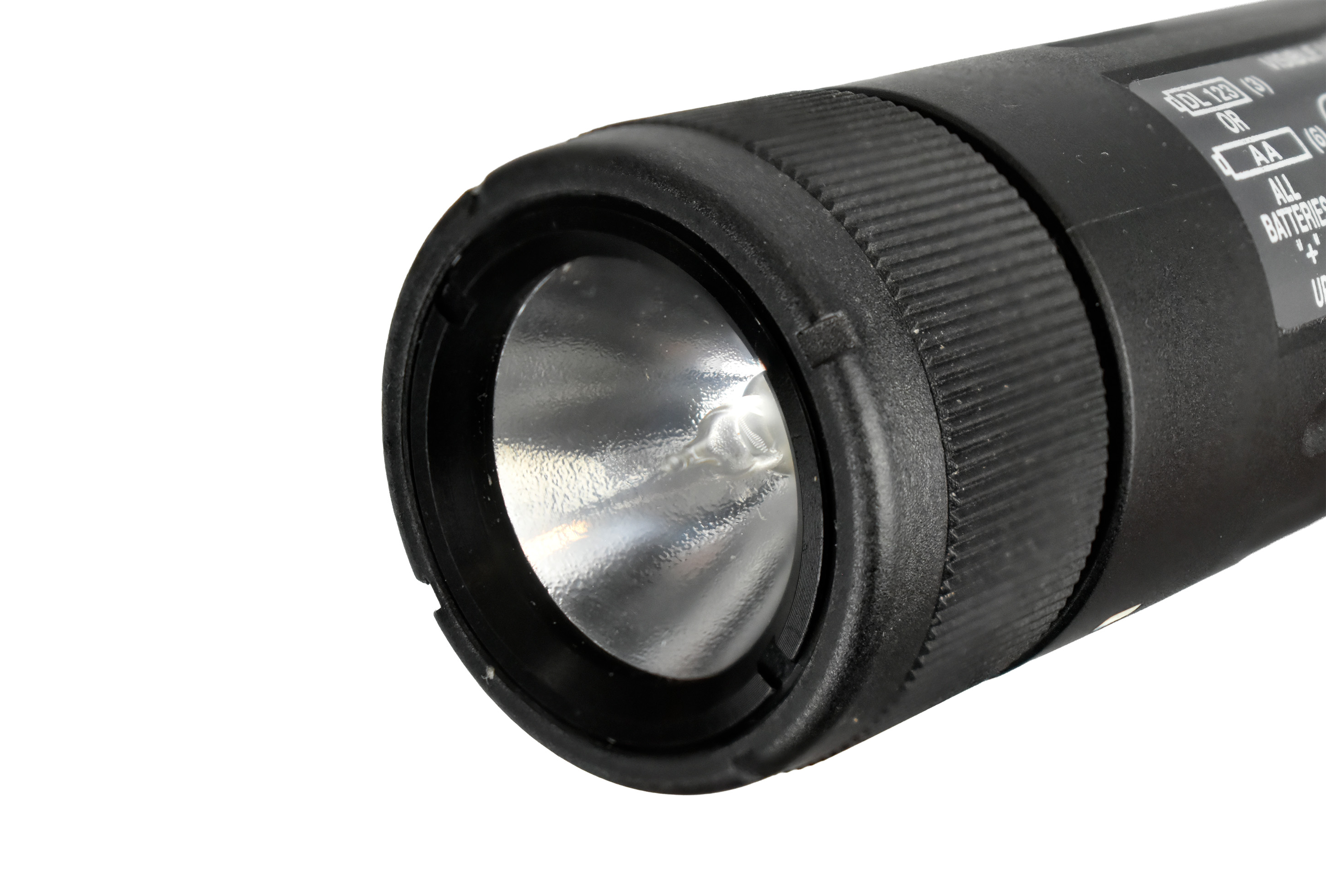 Close-up view of a flashlight with a shiny reflector and textured grip, showcasing the bulb and operational markings.