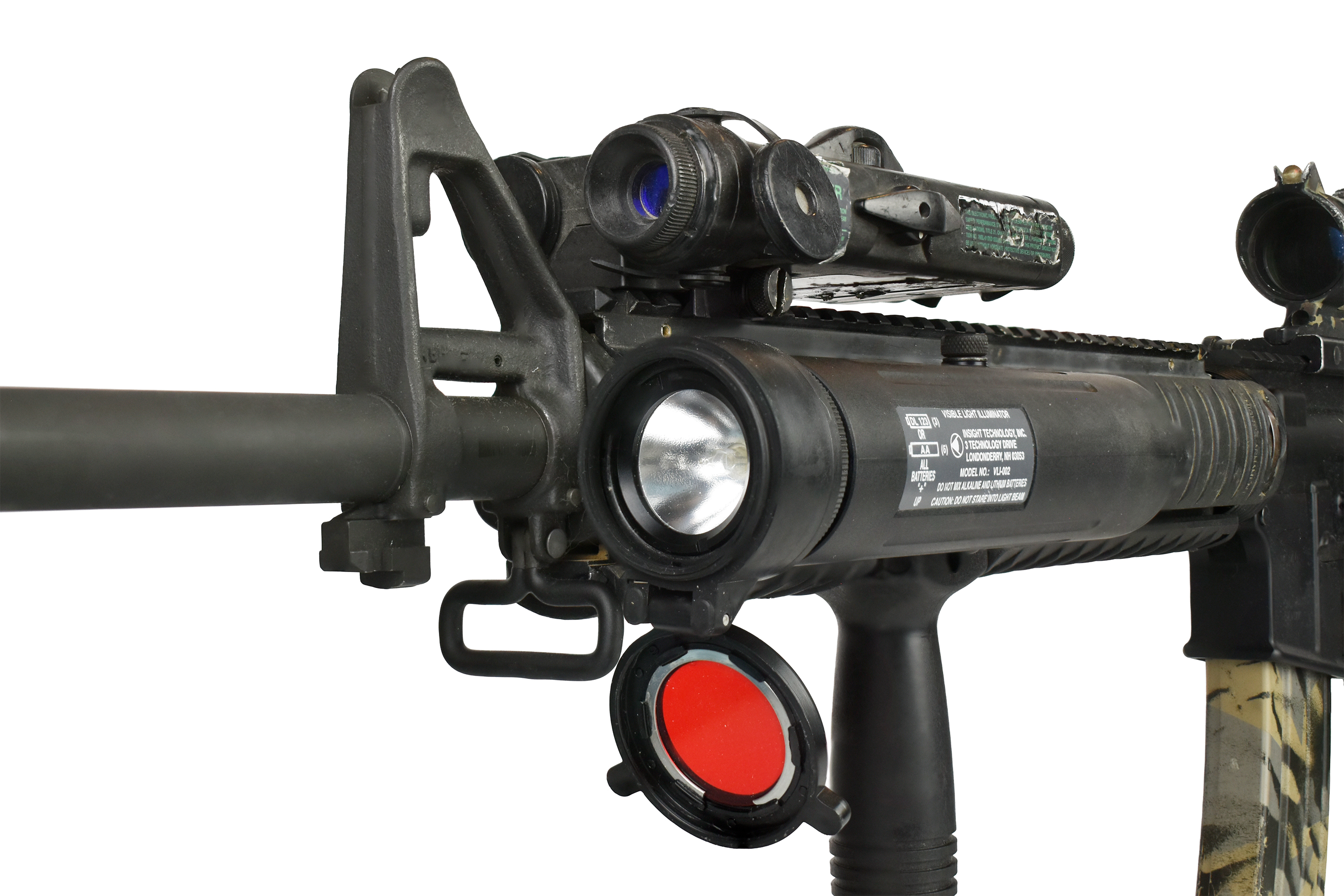 Close-up view of the Insight VLI (Visible Light Illuminator) mounted on a rifle, featuring a large flashlight and a red lens cap.