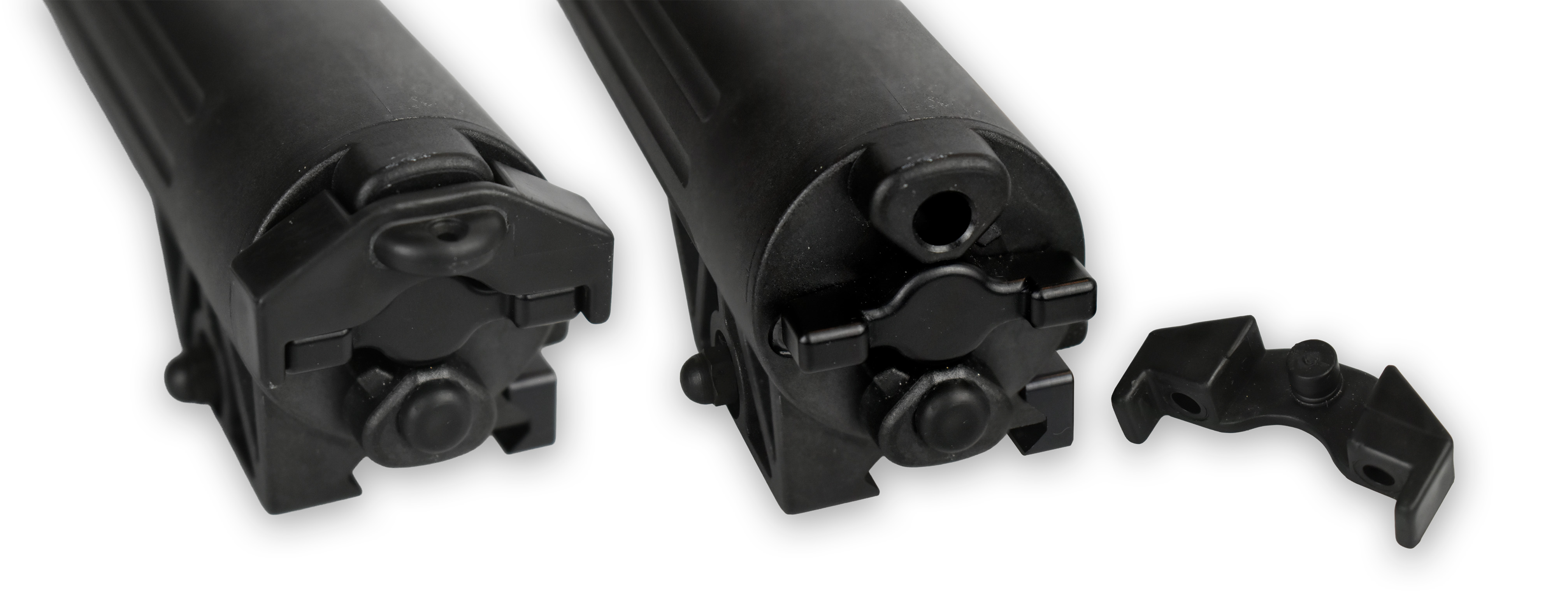 Two black rail attachment clamps for a device, with a separate connecting piece visible.