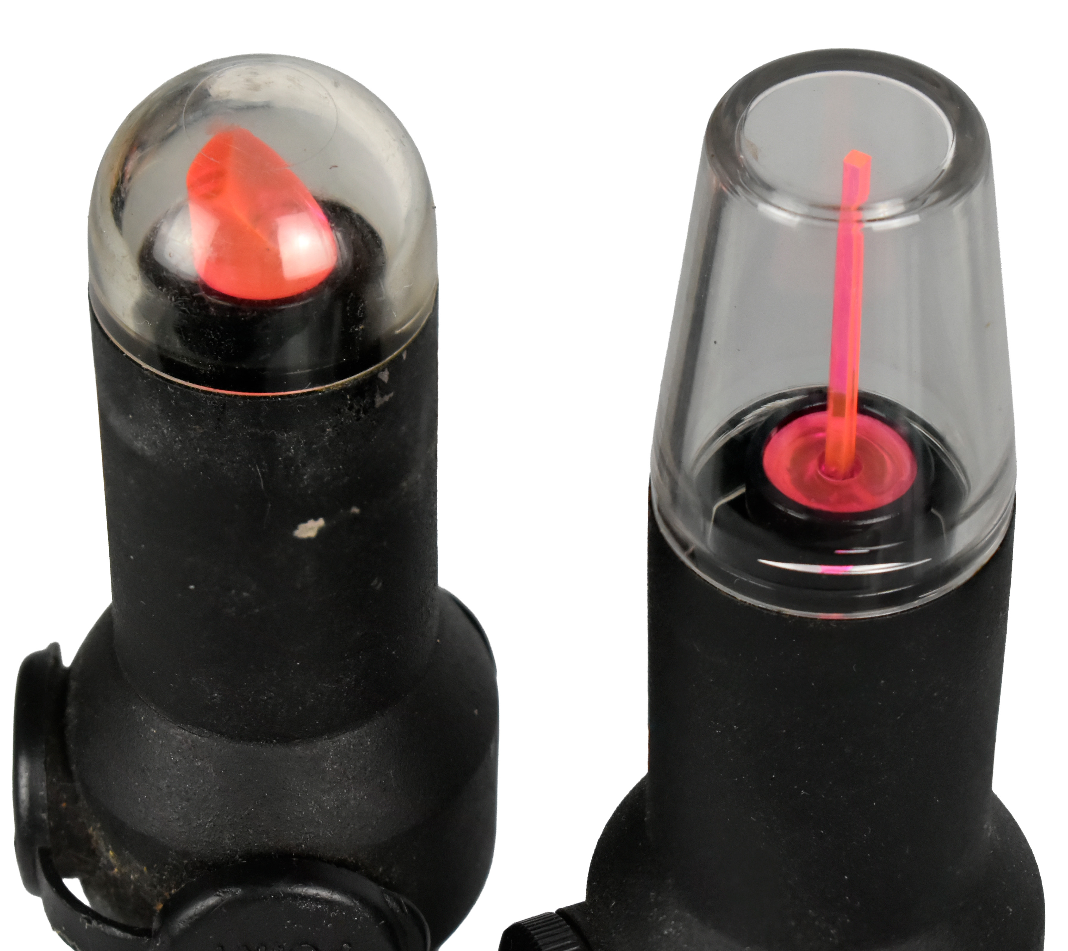 Two optical devices for firearms, featuring different designs with colored reticles. The left device has a dome-shaped lens with a red dot, while the right device has a transparent cover with a glowing pink reticle.