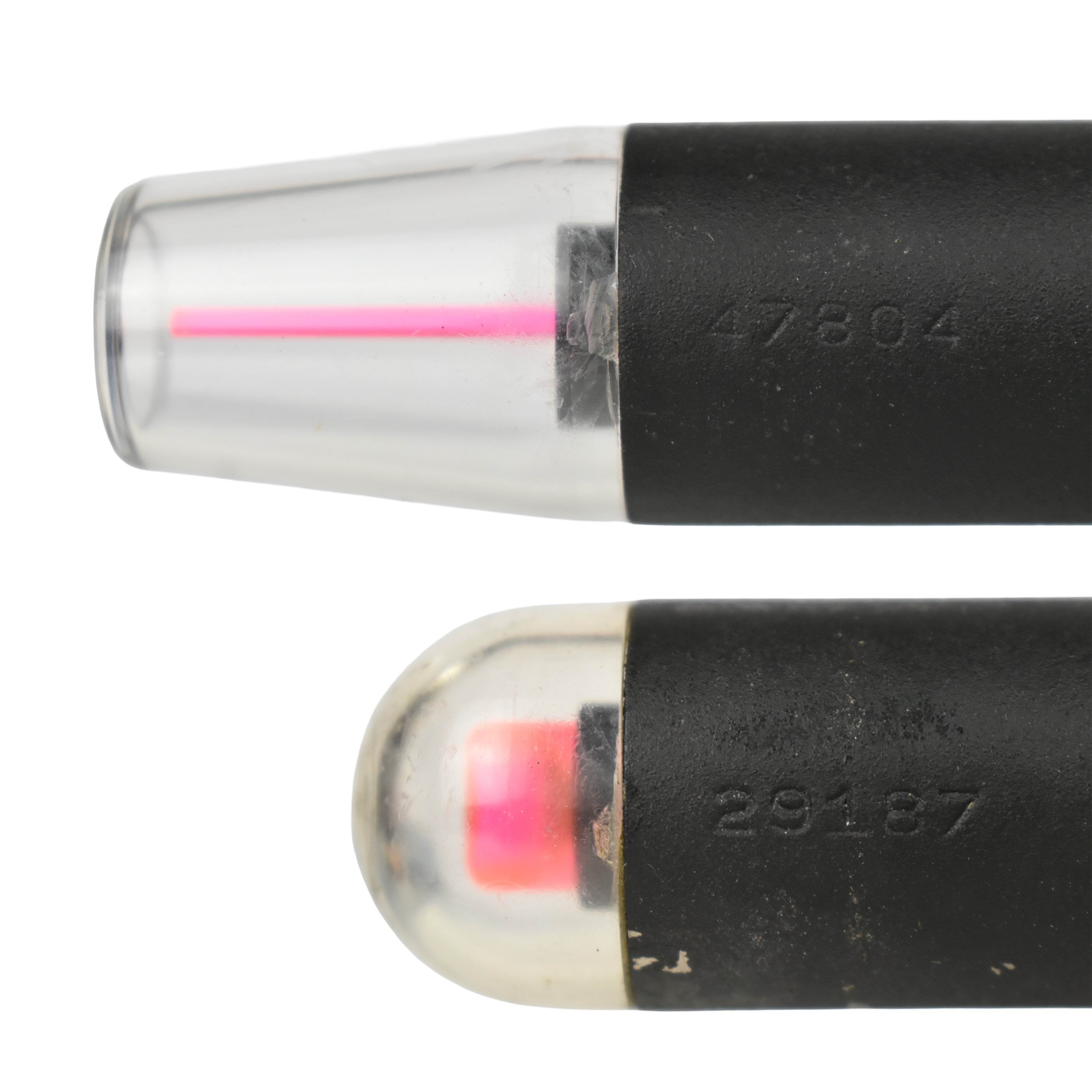 Close-up of two optical devices showing their lenses and internal components, featuring visible pink reticles.