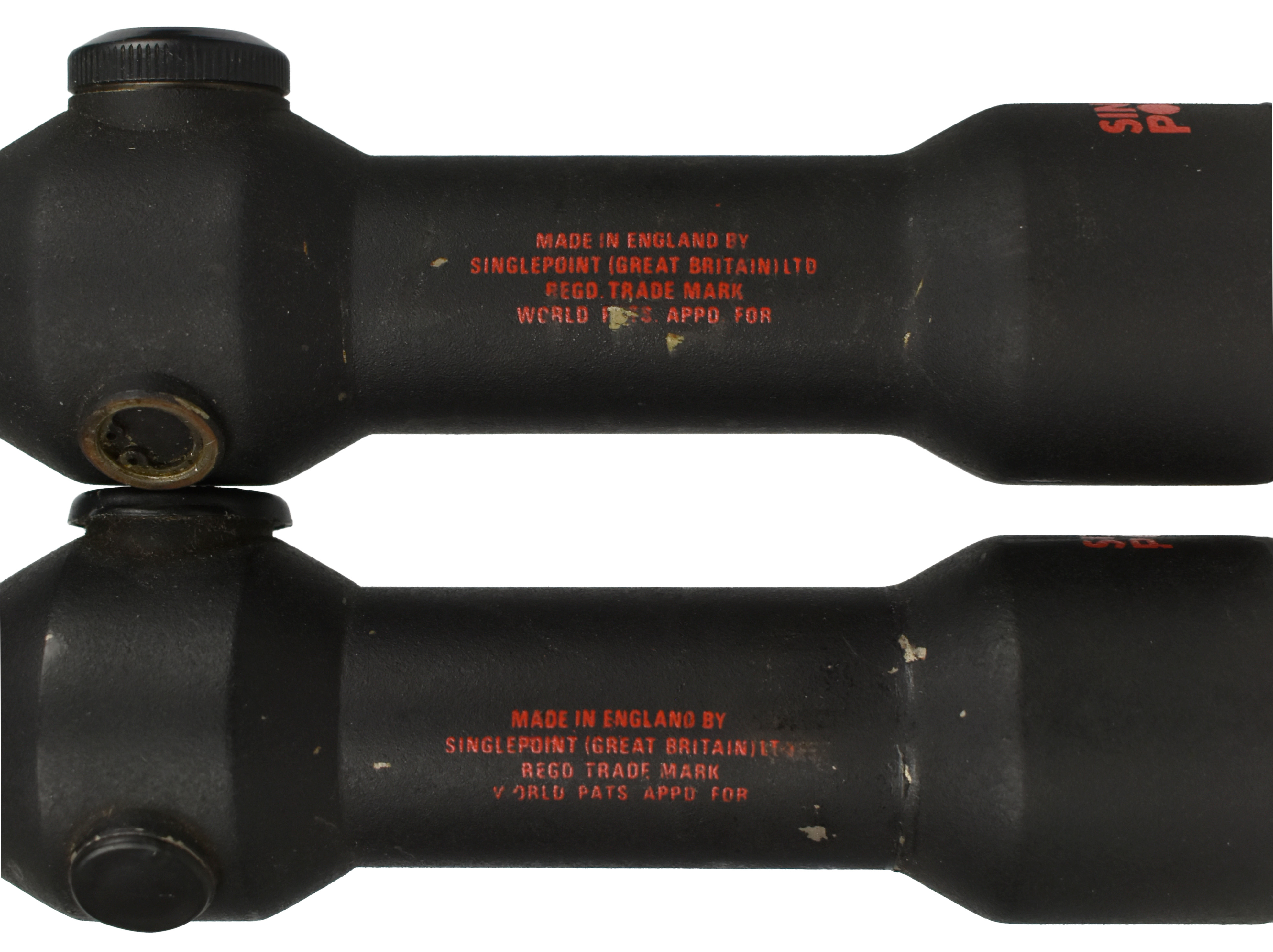 Close-up of two Singlepoint sights with visible branding and markings, emphasizing their design and manufacturing details.