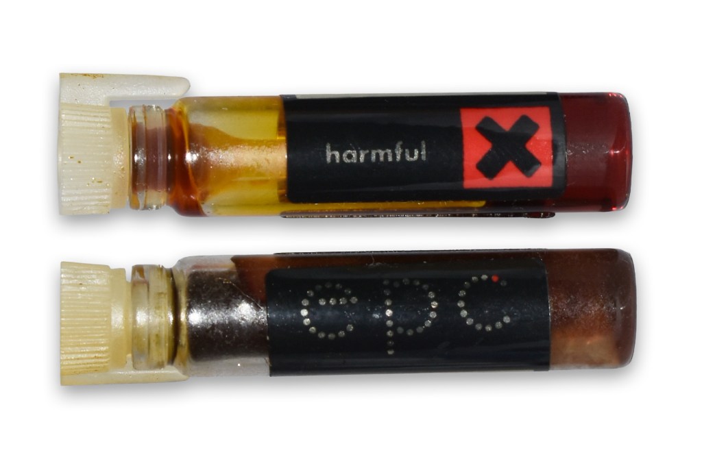 Image of two vials, one labeled 'harmful' with a red cross and the other labeled 'epc', showcasing the contents with amber and brown colors.