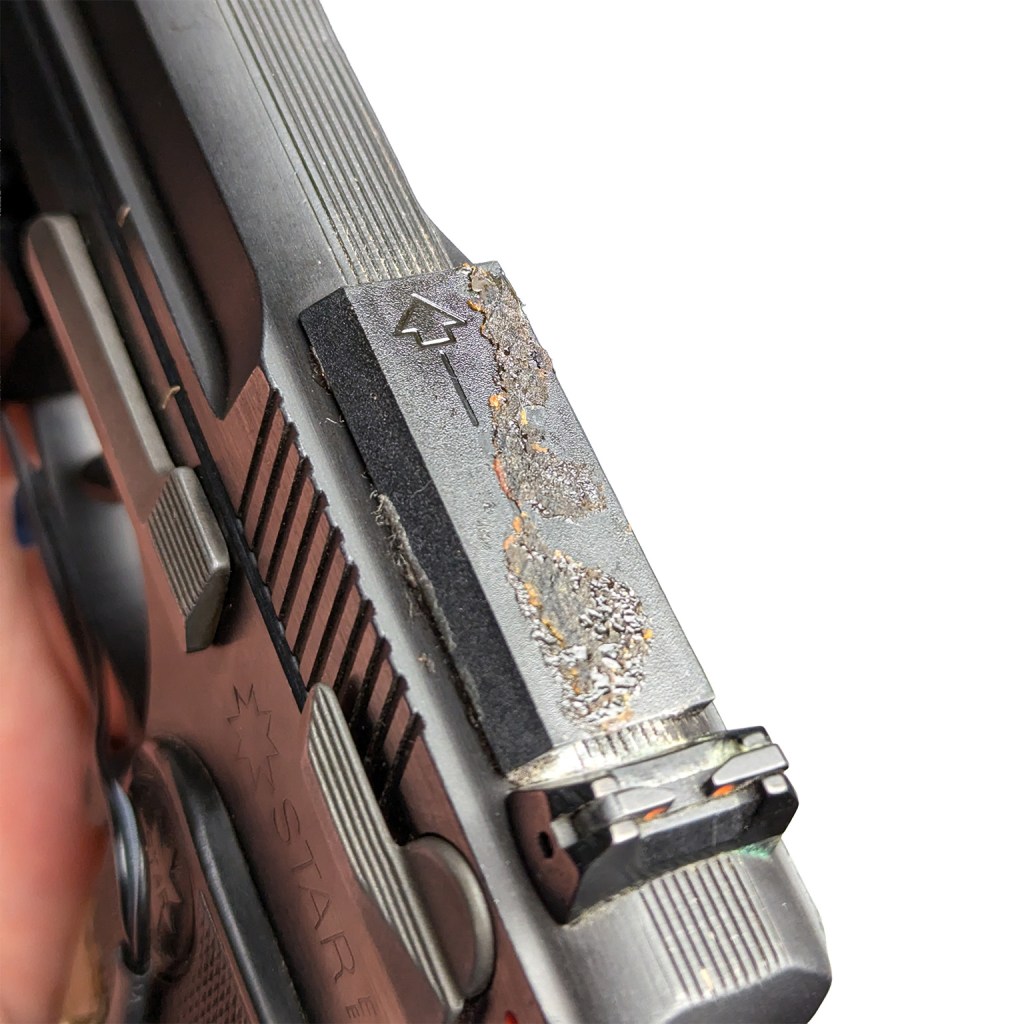 Close-up view of a damaged Star 30M handgun slide, showing wear and tear around the optics mounting area.