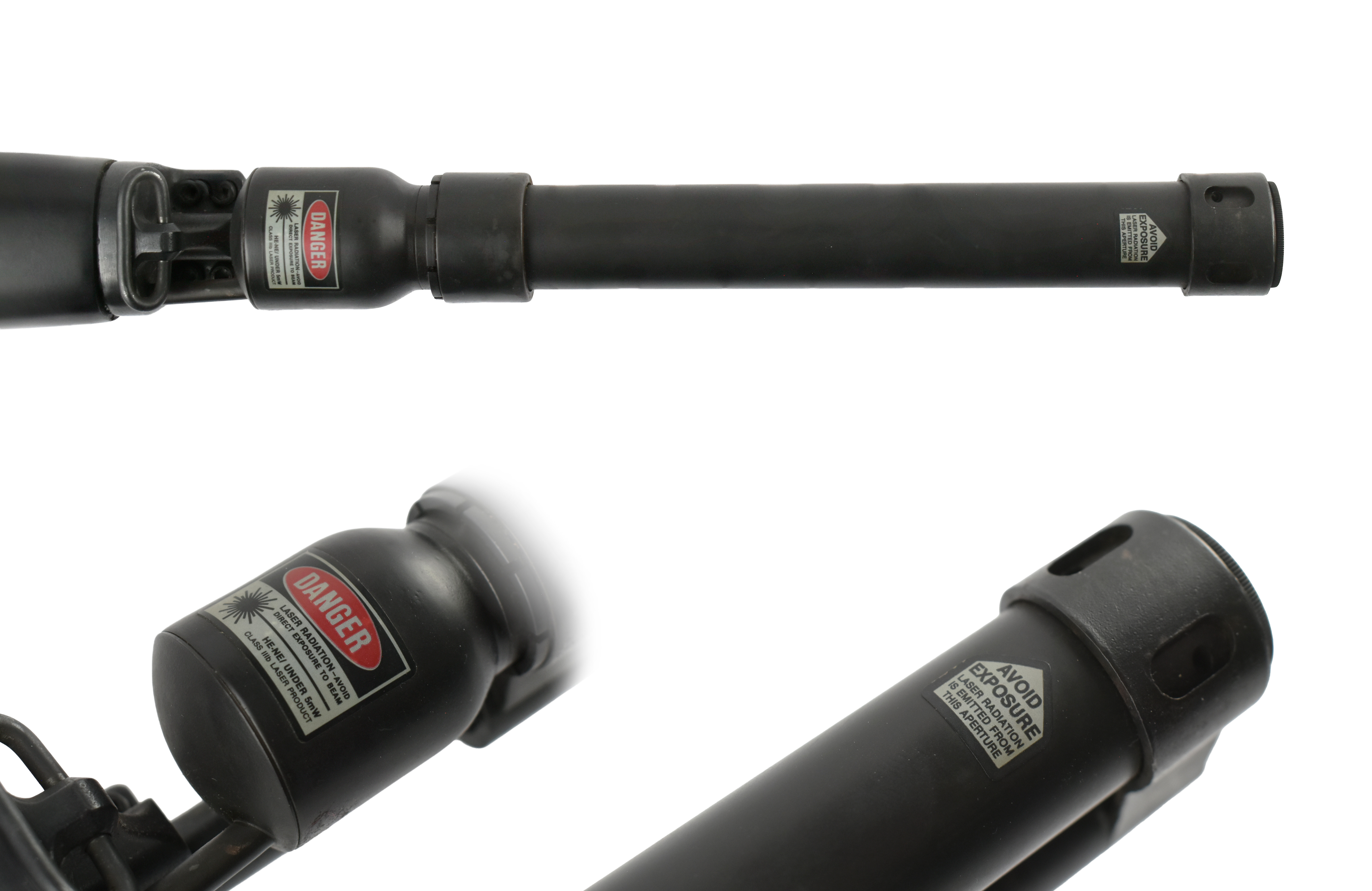 Close-up view of a laser attachment for a firearm with warning labels indicating danger and precautions.