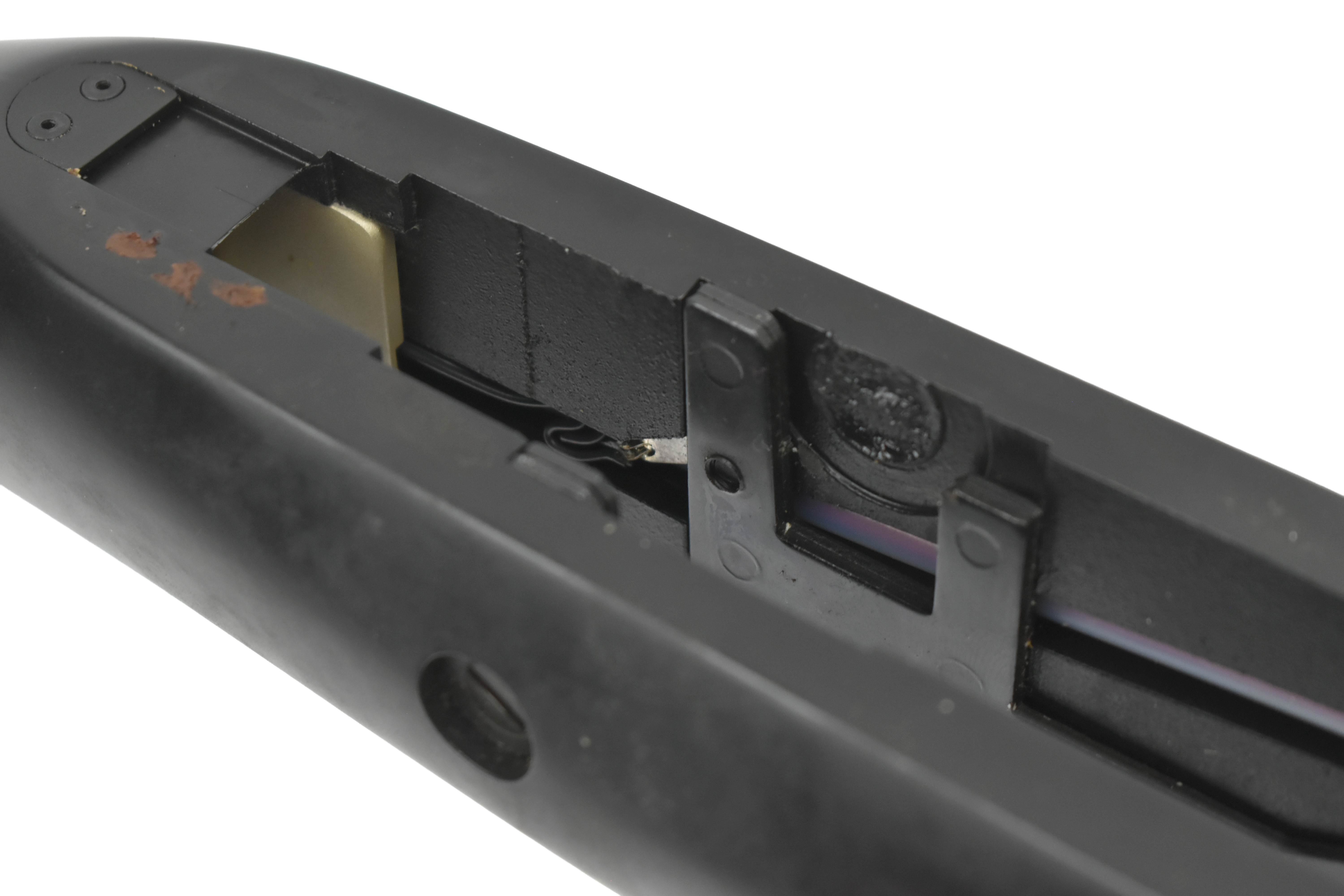 Close-up view of the internal mechanism of a laser-equipped firearm, showcasing components mounted in the stock.