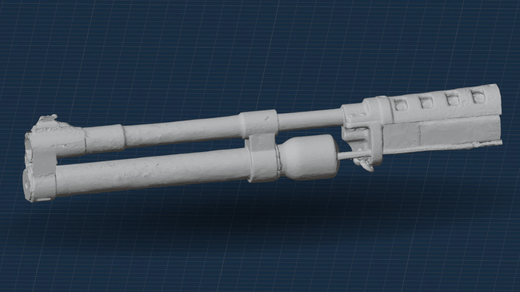 3D model of a mechanical device with two long cylindrical components and various intricate details, displayed against a dark grid background.